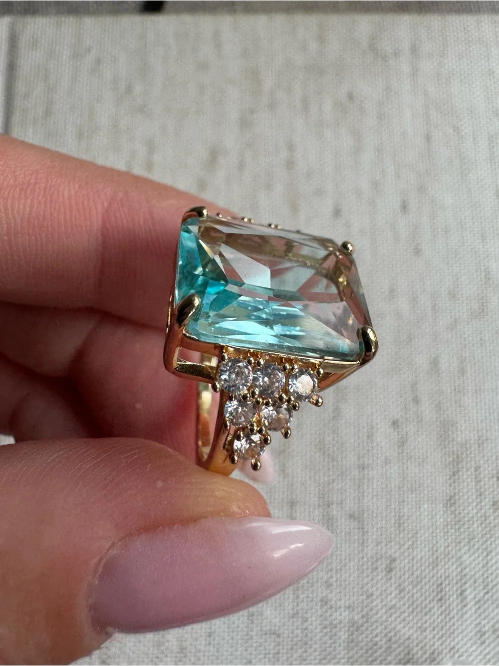 Stunning gold tone ring with blue crystal